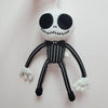 A white cartoon skeleton dog plush toy with black features and striped limbs.