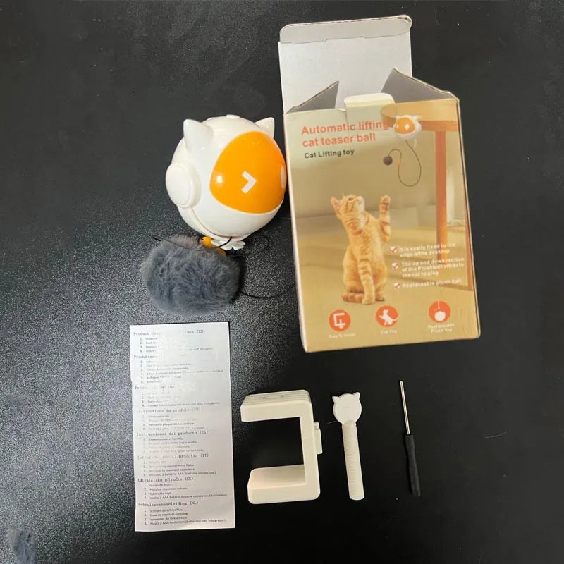 A white automatic lifting cat toy ball is shown next to its components, including a small plastic piece and a screwdriver.