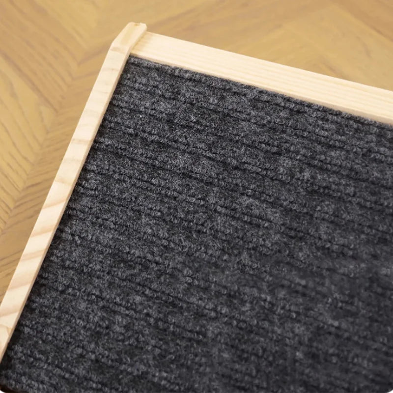 Close-up view of solid wood pet stairs with non-slip steps and dark gray carpeted surface.