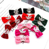 A collection of glitter dog hair clips in various colors like black, red, pink, and green with crown designs.