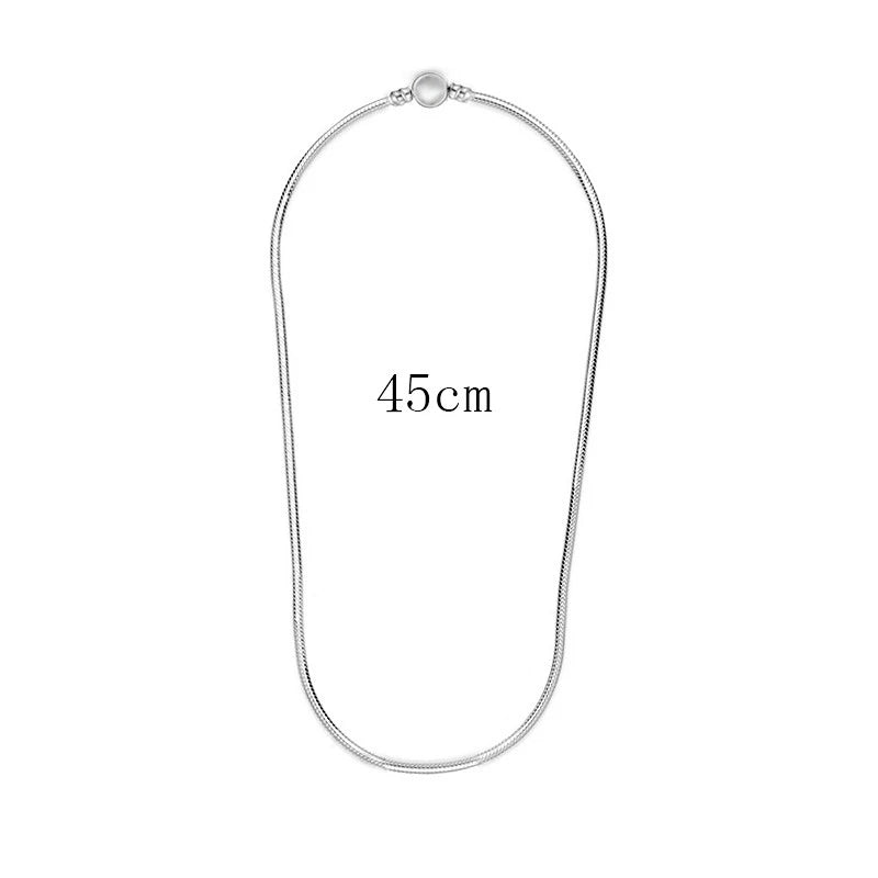 A silver snake chain necklace with a heart charm displayed against a white background.
