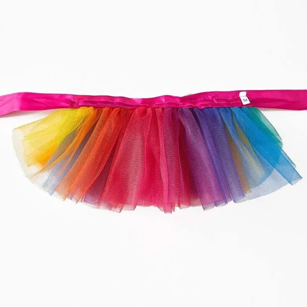 A colorful tulle tutu dress for a small dog, featuring multiple shades of pink, orange, purple, and blue.