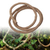 A coiled brown artificial reptile vine used for terrarium decor, resting on green foliage.