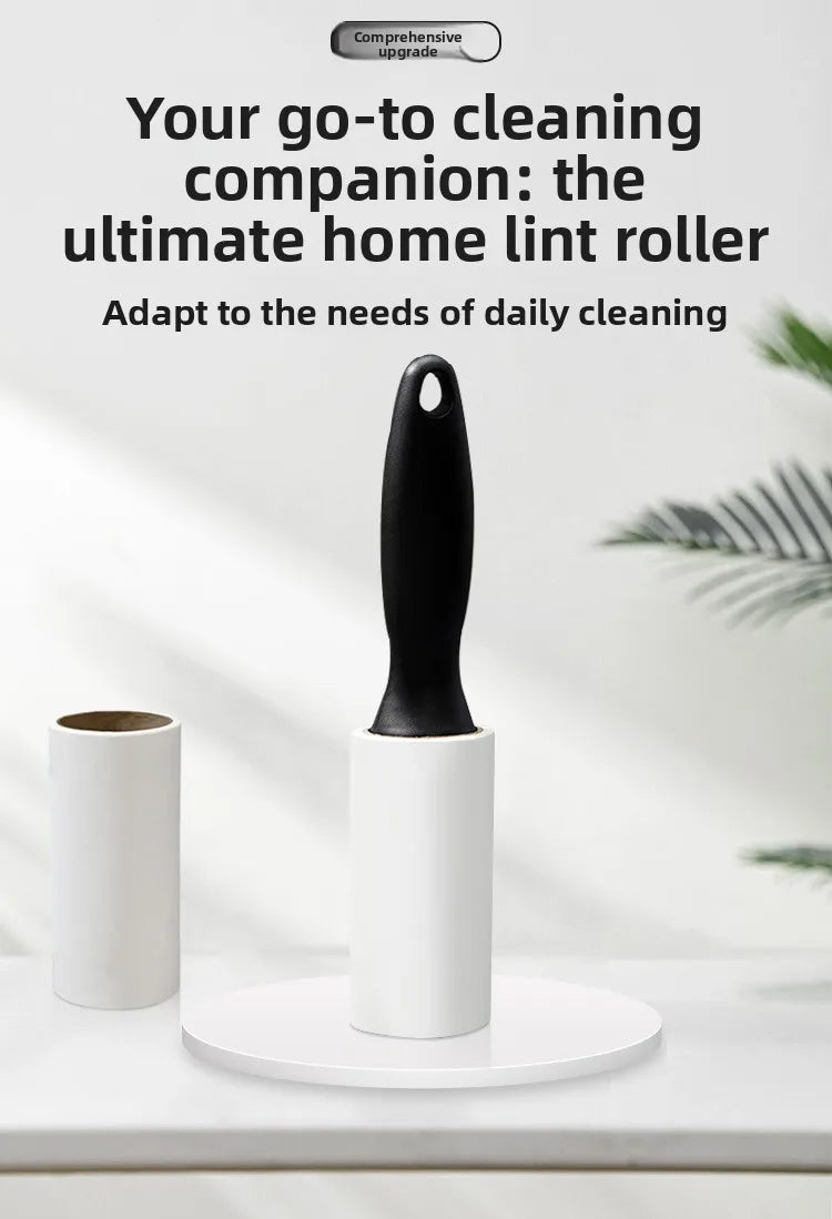 A black lint roller with a white cylindrical holder is shown on a white surface.