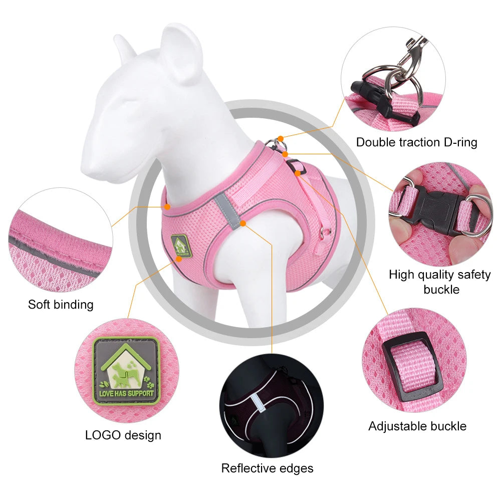 A pink mesh dog harness for a small pet, showing features like soft binding, double traction D-ring, and adjustable buckle.