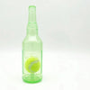 A clear green glass bottle containing a yellow squeaky tennis ball chew toy for dogs.