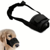 Black adjustable soft dog muzzle with a strap and mesh nose piece shown next to a golden retriever.