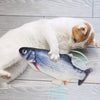 A white cat is interacting with an electric floppy fish toy that emits light waves.