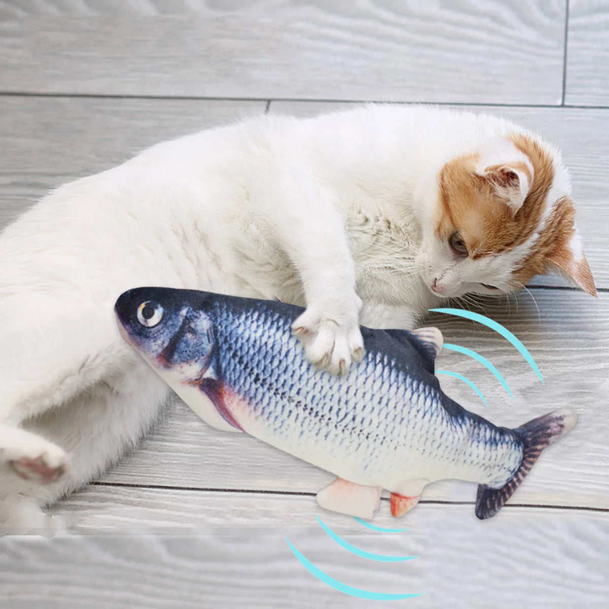 A white cat is interacting with an electric floppy fish toy that emits light waves.
