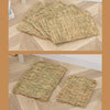 Several rectangular mats made of natural straw are shown on a wooden floor.