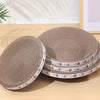 Stack of round, beige corrugated cat scratching pads with small cat designs on the edge.