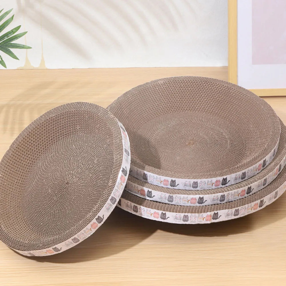 Stack of round, beige corrugated cat scratching pads with small cat designs on the edge.