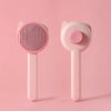 A pink one-button pet hair removal brush for cats and dogs shown against a light pink background.