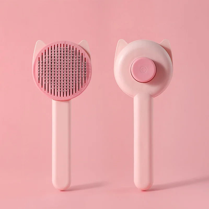 A pink one-button pet hair removal brush for cats and dogs shown against a light pink background.