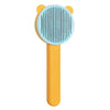 An orange pet hair removal brush with a light blue silicone bristles and a yellow handle.