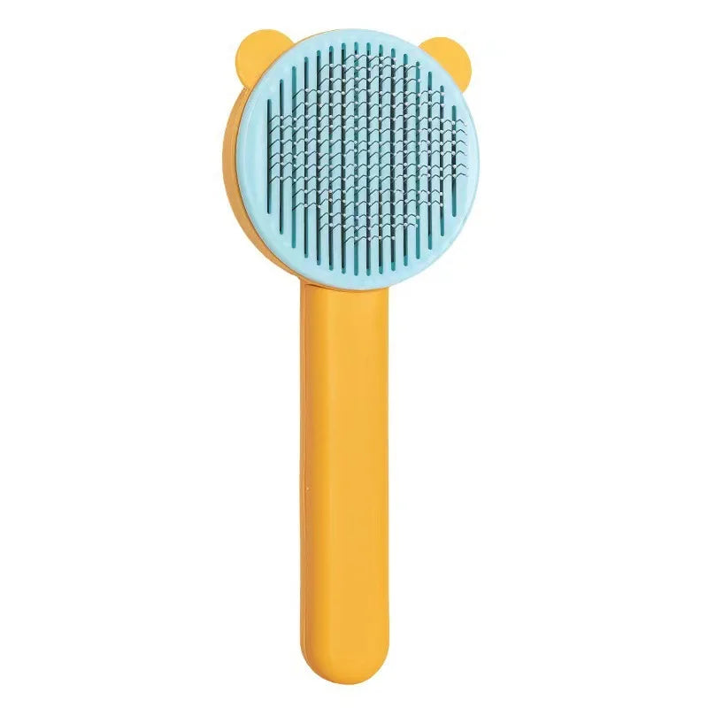 An orange pet hair removal brush with a light blue silicone bristles and a yellow handle.