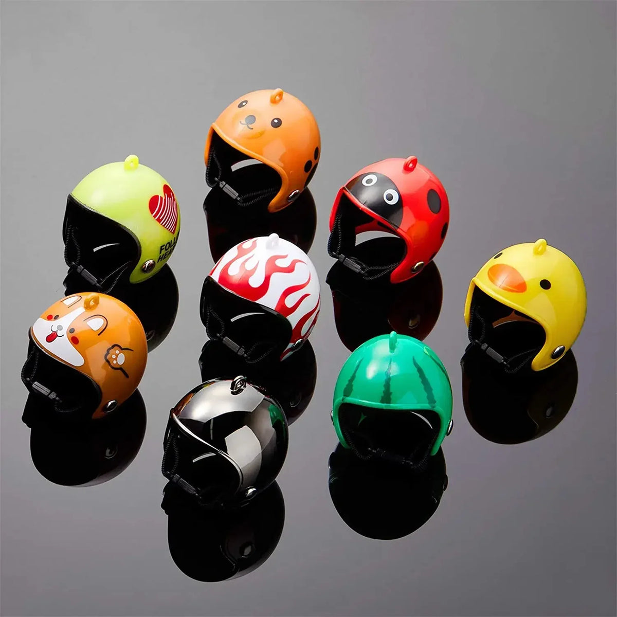 Eine Sammlung von neun leuchtend bunten Schutzhelmen für Haustiere, darunter Orange, Gelb, Rot und Grau