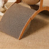 A wooden cat scratcher ball with a sisal-covered surface resting on a beige carpet.