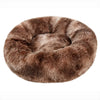A round, brown faux fur pet bed for dogs and cats.