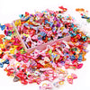 A pile of 30-piece handmade dog bows in various bright colors and patterns for hair accessories.