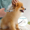 A person is using safe round-tip dog grooming scissors to trim the fur of a light brown dog.