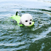 A white dog is wearing a neon yellow life jacket floating on the water.