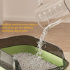 A clear plastic cat litter box is shown with sand being added, demonstrating its ease of installation.