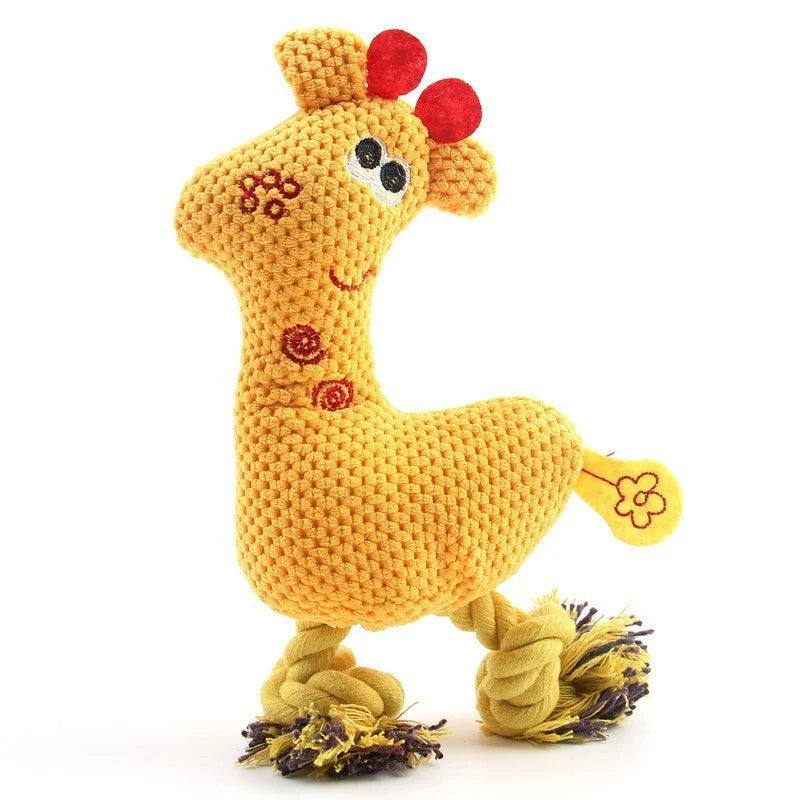 A yellow plush toy shaped like a giraffe with a textured body and a red nose.