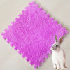 A bright purple, textured fleece pet warming mat with a small white rabbit resting on it.