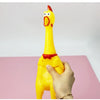 A hand is holding a yellow squeaky rubber chicken dog toy with a red beak against a pink background.