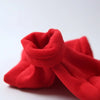 A bright red cozy fleece dog hoodie folded and displayed on a white surface.