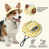 A dog wearing a yellow duck print pet cap, demonstrating comfortable ear holes and sun protection.
