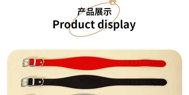 Two leather dog collars, one red and one black, are displayed on a light surface.