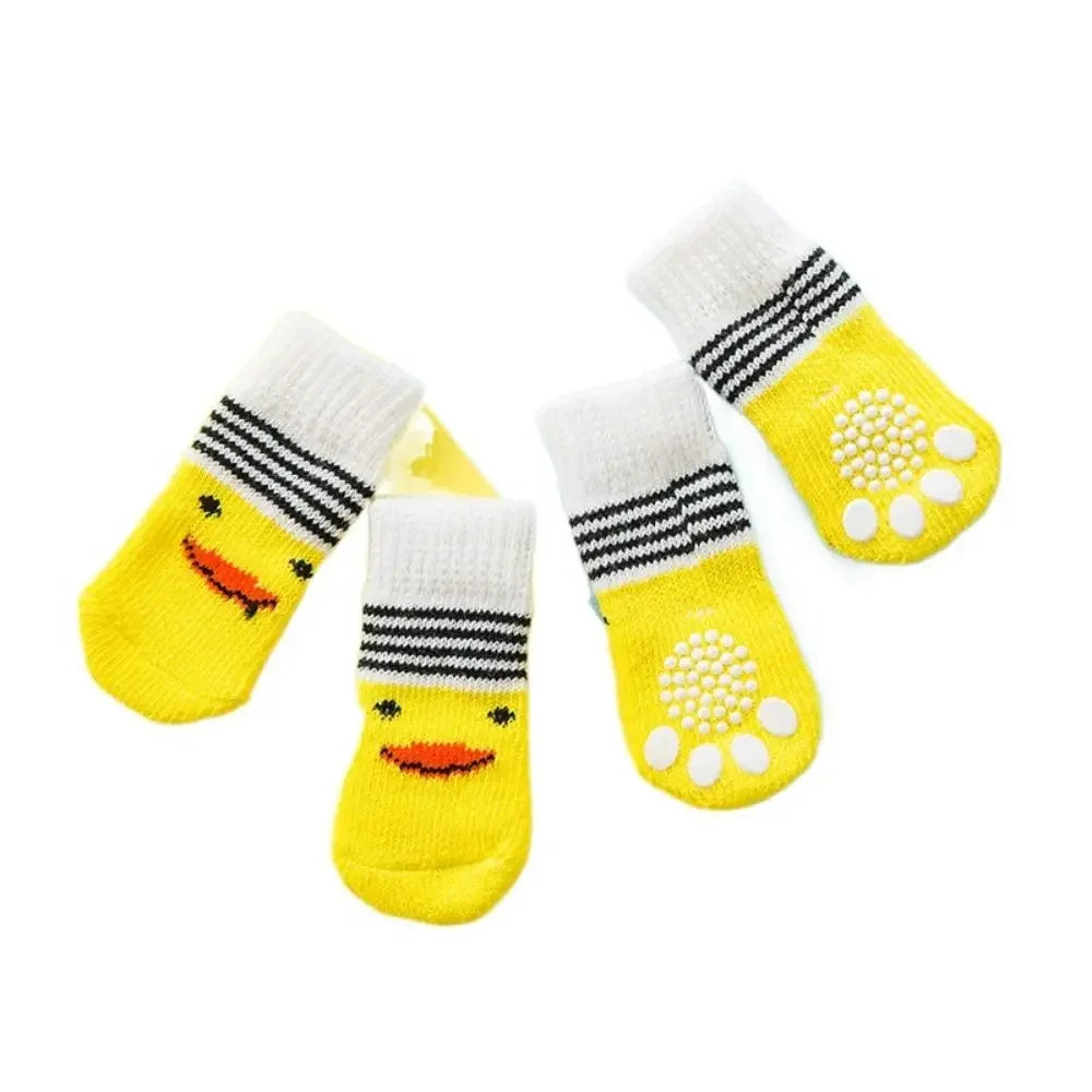 A pack of four yellow anti-slip pet socks for dog and cat protection