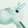 A close-up of a white grooming tool with a clear bottle attached, used for adding shampoo or conditioner.