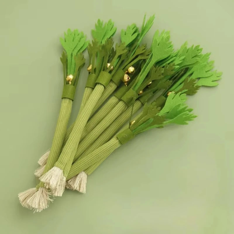 A bunch of green catnip molar sticks with gold accents arranged on a light green background.