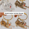 A series of transparent and solid cat figurines used as keychain storage items.