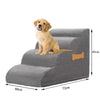 A golden retriever puppy is standing on a gray foam pet stair with a non-slip cover.