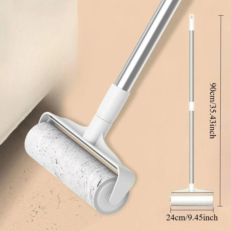 A silver retractable lint roller mop with a white handle and roll is shown against a beige background.