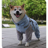 Un Shiba Inu feliz vistiendo un impermeable para mascotas azul de doble capa con arnés al aire libre.