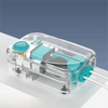 Clear plastic aquarium air pump with a light blue component and tubing resting on a white surface.