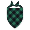 A dark green and black plaid bandana tied in a bow for a dog