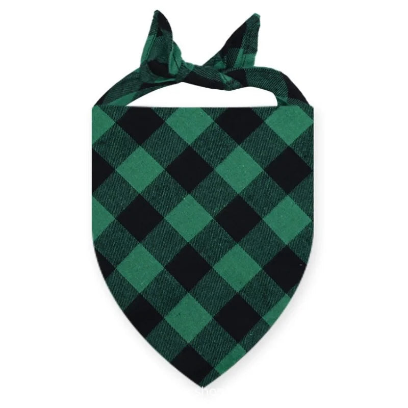 A dark green and black plaid bandana tied in a bow for a dog