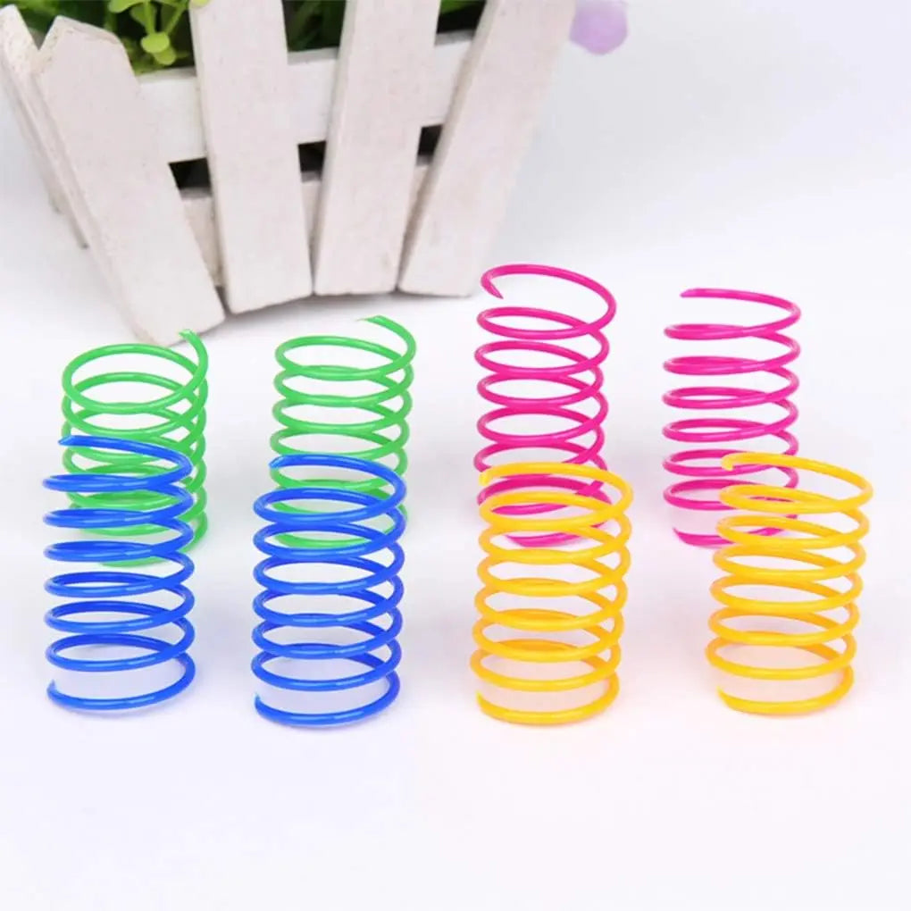 Eine Sammlung farbenfroher Spielsachen für den Frühling in verschiedenen Größen und Farben, darunter grün, blau, pink und gel