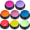 A collection of brightly colored, round buzzer buttons for pet communication recording.