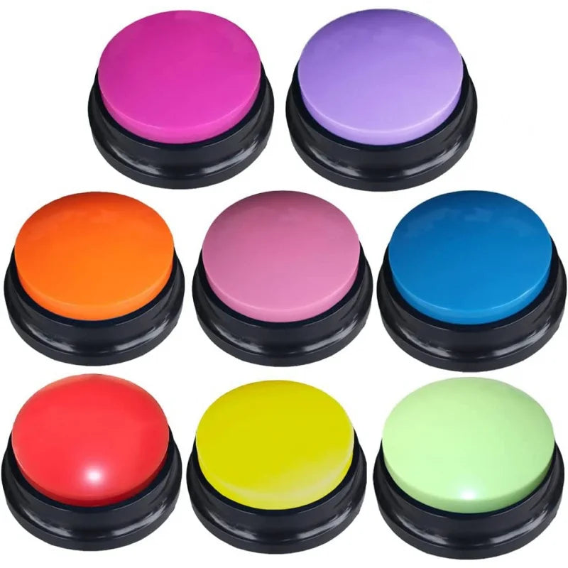 A collection of brightly colored, round buzzer buttons for pet communication recording.