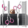 A set of precision stainless steel pet grooming shears with pink handles displayed on a black case.