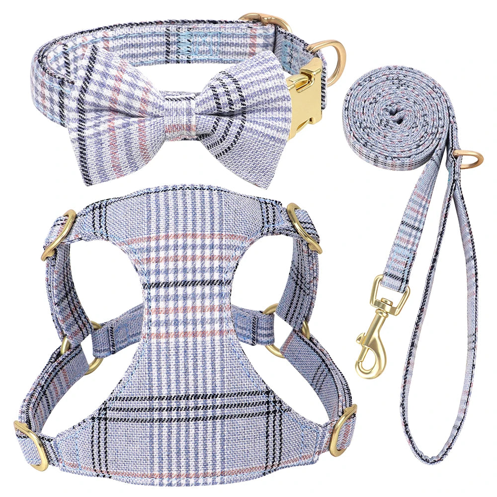 A plaid dog collar, harness, and leash set featuring a bowtie in blue and gray stripes.