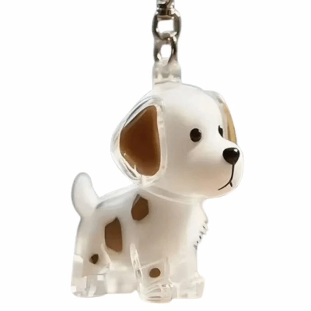 Llavero de perro de silicona con orejas caídas y manchas marrones.