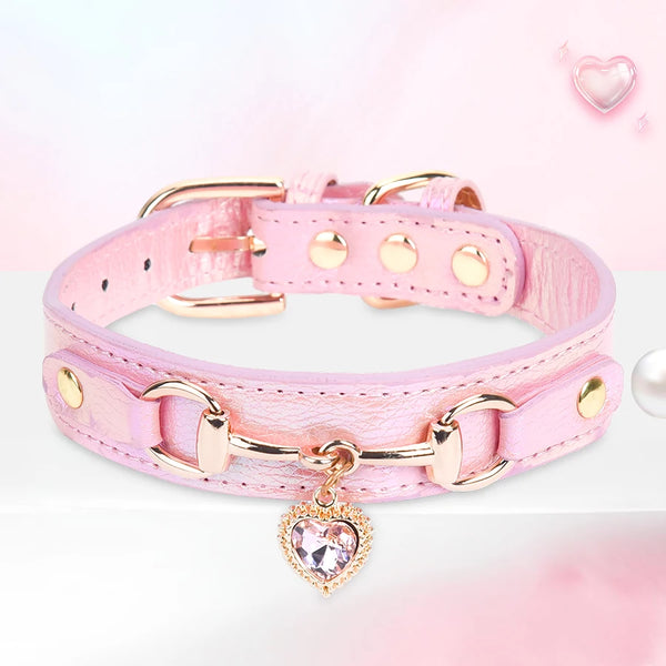 Pink leather dog collar with gold hardware and a clear rhinestone heart charm